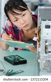 Female Technician Fixing Computer