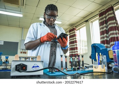 Female technician at the Vocational training centre repairing a mobile phone in Dar es Salaam, Tanzania on October 1, 2021