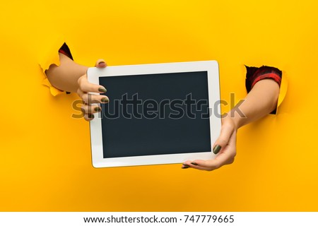 female teen hands using tablet pc with black screen, isolated