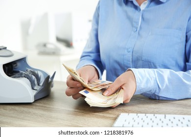 Female Teller Counting Money At Cash Department, Closeup