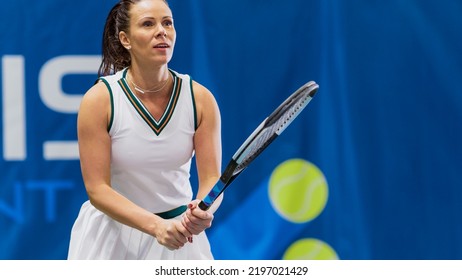 Female Tennis Player Hitting Ball With A Racquet During Championship Match. Professional Woman Athlete Successfully Receives Strike. World Sports Tournament. TV Channel Broadcast Concept.