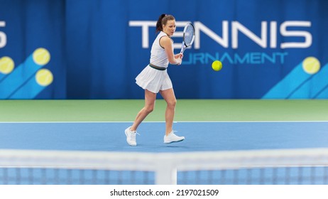 Female Tennis Player Hitting Ball With A Racquet During Championship Match. Professional Woman Athlete Receives And Lands Perfect Backhand Shot. World Sports Tournament Footage.