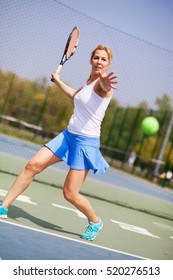 Female Tennis Player On The Court.