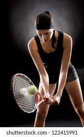 Female Tennis Player With Racket And Ball On Black Background