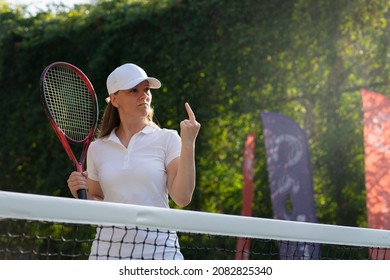 a female tennis player shows her middle finger an indecent rude gesture to a referee or opponent. dissatisfied with the decision of the referee or the opponent or the result of the match, her failure