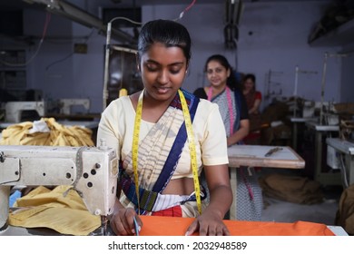 Female textile worker doing their work using sewing machine on production line - Powered by Shutterstock