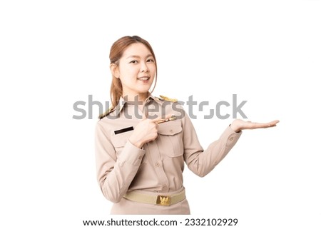 Female Thai government officer in khaki uniforms showing empty copy space for product, text or message on over isolated white background. Concept of advertising, product, sale promotion, presentation.