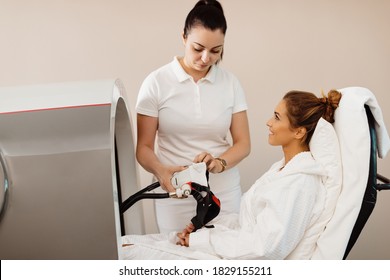 Female therapist is checking a mask before client's hyperbaric oxygen treatment at health spa. - Shutterstock ID 1829155211