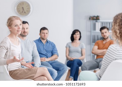 Female Therapist Discussing Problems With Her Patients During An AA Support Group Meeting