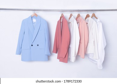 Female Three Business Formal Suit Jacket And Two Coral Color Suit With Shirt Isolated On Hanger