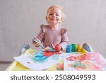 Female toddler drawing at table