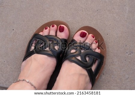female toes with rings, red pedicure