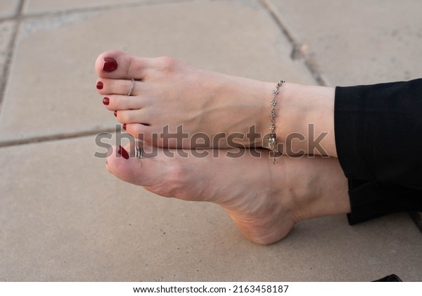 female toes with rings, red\
pedicure
