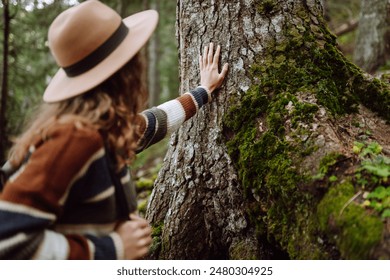 Female tourist with backpack and travel equipment touching tree while standing in the forest. Concept to love nature and tree . Environment ecology and Earth Day concept. - Powered by Shutterstock