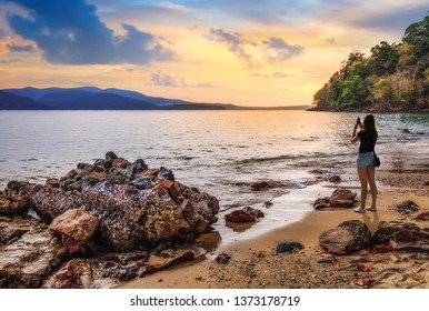 Female tourist clicking beach sunset at Chidiya Tapu Port Blair Andaman with scenic landscape 