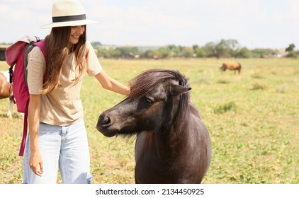 Female Tourist With Cute Pony Horse In Wildlife Sanctuary