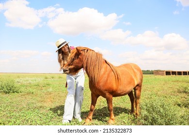 Female Tourist With Cute Pony Horse In Wildlife Sanctuary