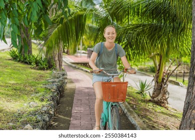 Female tourist cycling through the charming village of Bacalar, Mexico. Quintana Roo travel, scenic bike paths, and eco-friendly exploration concept - Powered by Shutterstock