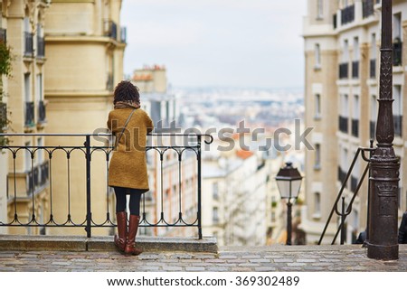 Female tourist enjoying city view on a street of Montmartre, Paris, France
