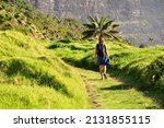 Female tourist hiking on Lord Howe Island with Mount Gower in the background, New South Wales, Australia
