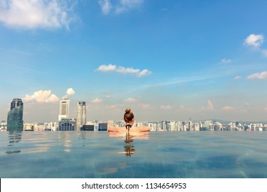 Female Tourist In Infinity Pool Of Marina Bay Singapore