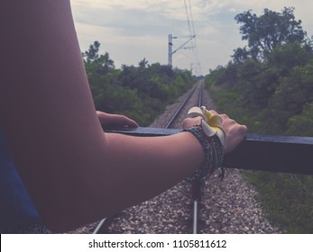 Female Tourist Looking At The Railway Track From The Train.