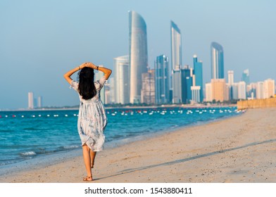 Female tourist on Abu Dhabi city beach with a view