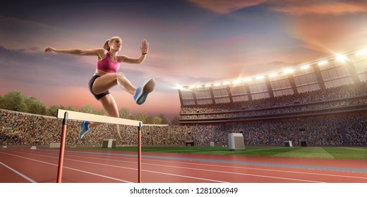 Female Track And Field Athlete Jumps Over The Barrier At The Running Track In Professional Stadium