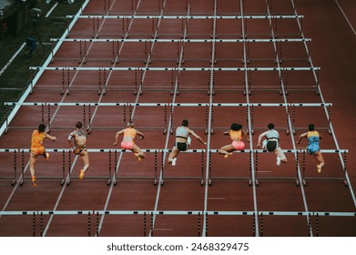 Female track and Field athletes at 100 m hurdles. Dynamic sport photo. Sprint race before world championship and summer game in Paris 2024. Professional Athletics Event. - Powered by Shutterstock