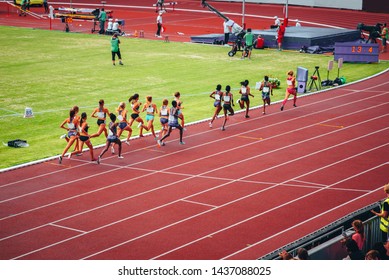 Female Track And Field Race At Athletics Stadium. Professional Female Runners. Concept Photo For Olympic Competition In Tokyo 2020