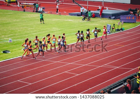Female track and field race at athletics stadium. Professional female runners. Concept photo for olympic competition in tokyo 2020
