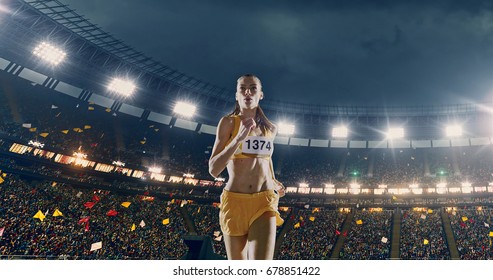 Female Track And Field Runner On The Professional Sports Arena With Bleaches Full Of People. Athlete Wears Unbranded Clothes. Arena And People On It Are Made In 3D And Animated.