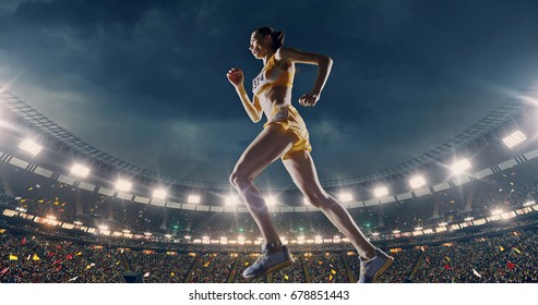 Female Track And Field Runner On The Professional Sports Arena With Bleaches Full Of People. Athlete Wears Unbranded Clothes. Arena And People On It Are Made In 3D And Animated.