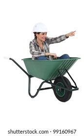 Female Tradesperson Sitting In A Wheelbarrow