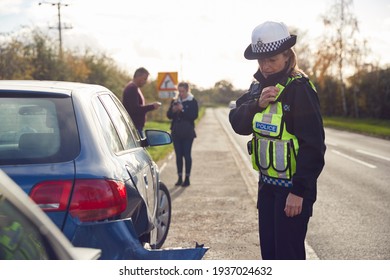 Female Traffic Police Officer Reporting Details Of Road Traffic Accident On Radio