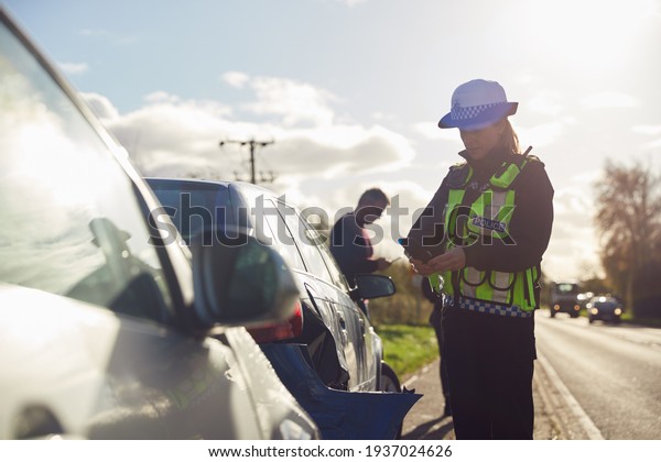 Female Traffic Police Officer Taking
Photos On Mobile Phone At Road Traffic
Accident