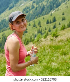 Female Trail Runner Drinking Water And Having A Break