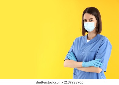 Female Trainee Nurse In Gloves And Mask On Yellow Background