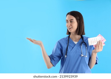 Female Trainee Nurse With Pads And Period Calendar On Blue Background