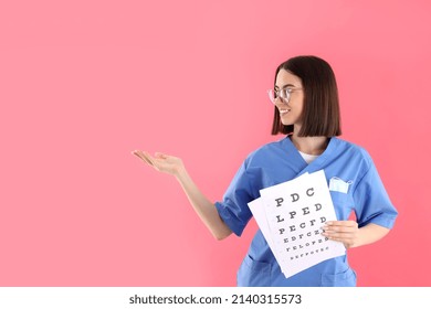 Female Trainee Nurse With Vision Test On Pink Background