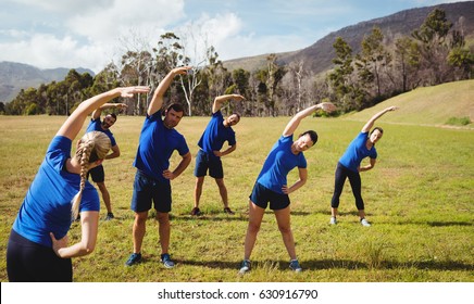 Female Trainer Giving Training To Fit People In Boot Camp