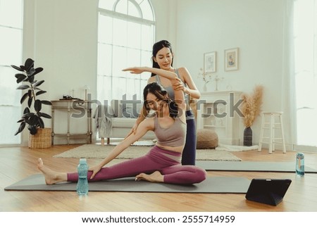 Similar – Image, Stock Photo A female trainer teaching a student how to do push-ups correctly.Outdoor sports in urban environment