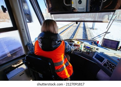 Female tram driver on workplace, view from behind. - Shutterstock ID 2127091817