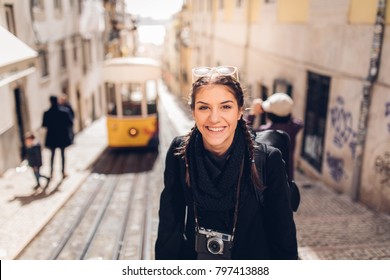 Female Traveler Woman Sightseeing In European Capital.Visitor In Lisbon,Portugal.Yellow Tram Route.Traveling Europe On A Budget.Studying Abroad.Photography And Travel Concept