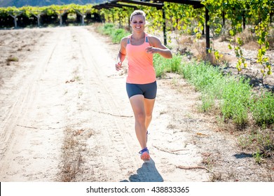 Female Triathlete Running On A Trail On A Bright Sunny Day Winelands And Vineyards Of The Western Cape Of South Africa