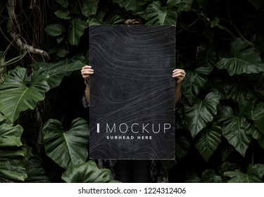 Female in a tropical background holding a signboard mockup