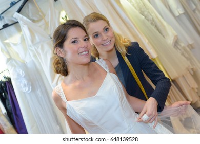 Female Trying On Wedding Dress In A Shop