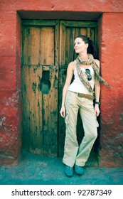 Female Turist At Front Of Old Door, Cuzco, Peru.