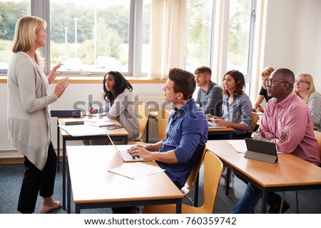 Female Tutor Teaching Class Of Mature Students
