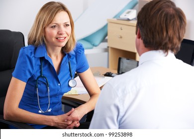 Female UK Doctor Talking To Male Patient